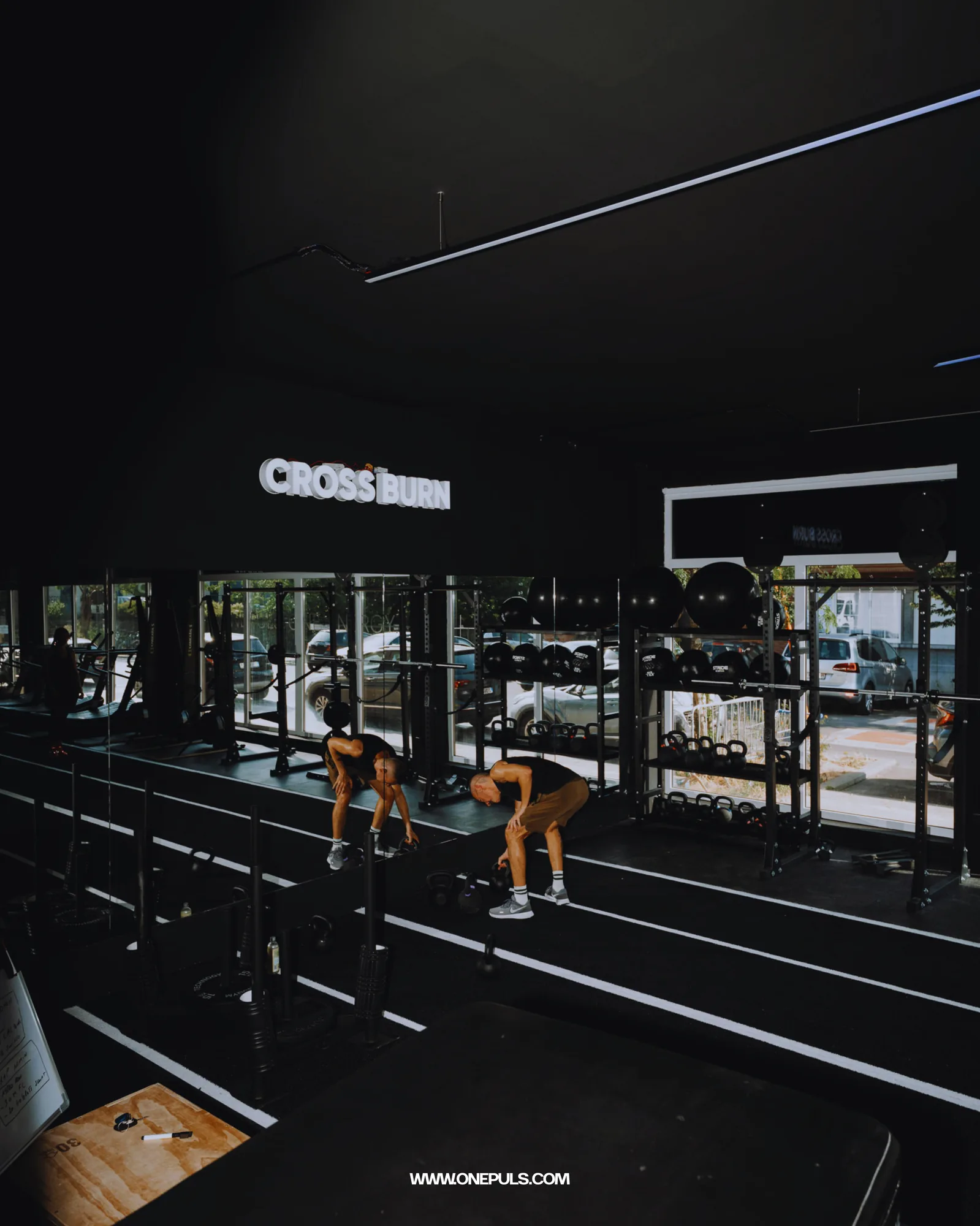 Wide view of the ONE PULS HYROX studio in Brussels with its lit sign